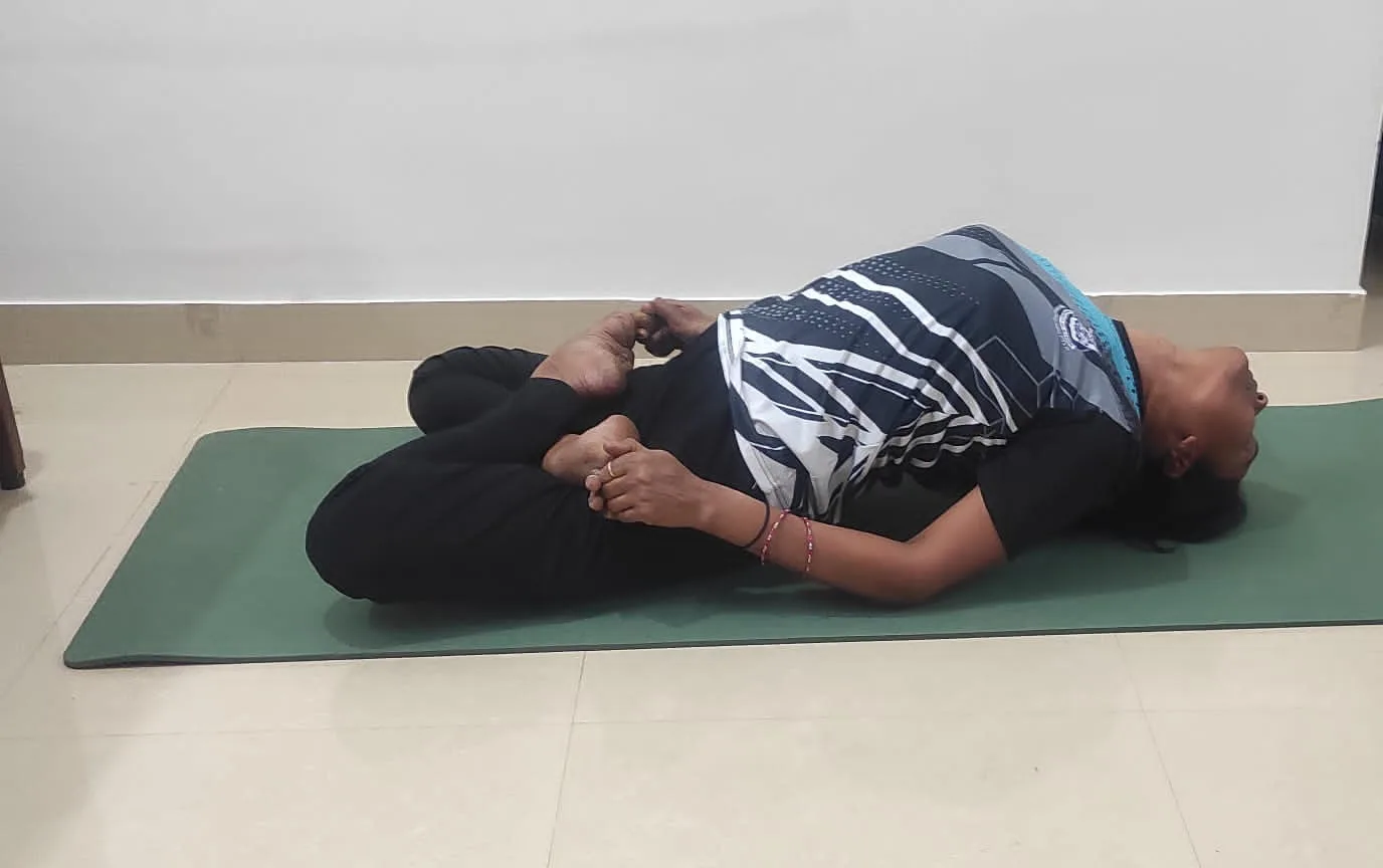 Resting in a reclined posture on a green mat